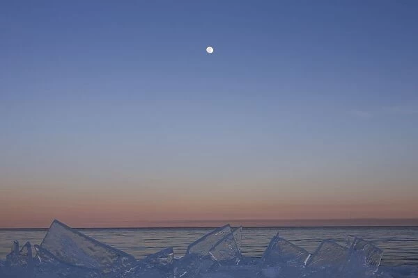 Full Moon At Dusk With Ice On Lake Superior; Grand Portage, Minnesota, United States Of America