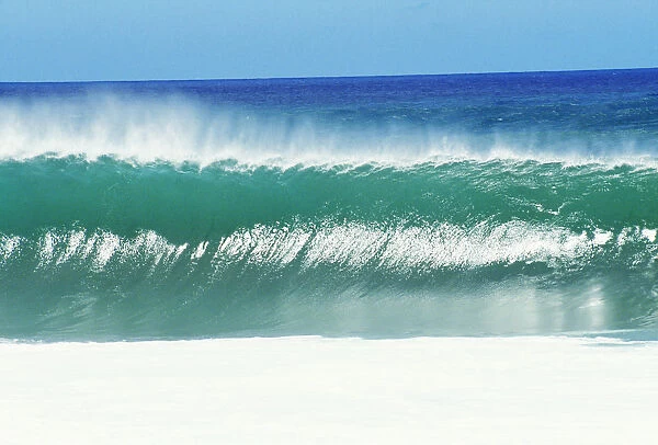 Shimmery Shorebreak Wave With Silver Waters In Foreground