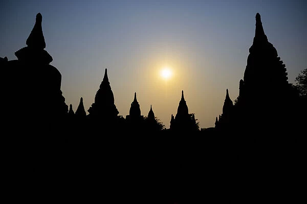 Silhouetted Buddhist temple at sunset, Myanmar
