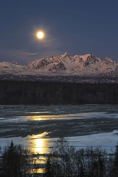 Super Moon As It Descended Over The Denali Range And Chulitna River, Along The Parks Highway; Trapper Creek, Alaska, United States Of America