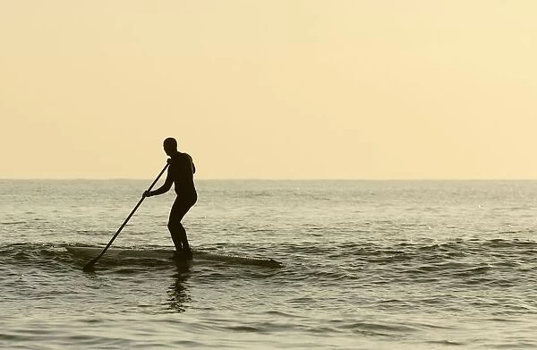 Surfer Steering Into Shore At Dusk