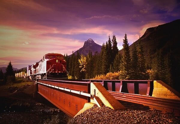 Train Going Over A Bridge; Banff National Park, Alberta, Canada
