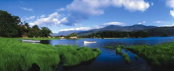 Upper Lake, Carrantuohill, Killarney, Co Kerry, Ireland; Boats In A Lake With Purple Mountains In The Distance