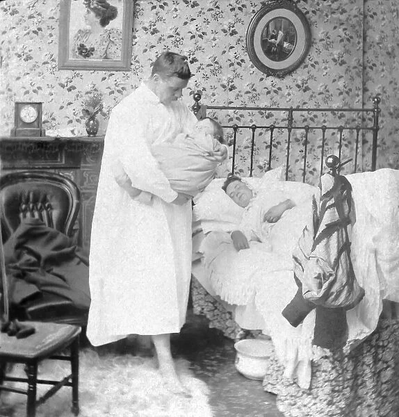 Victorian man feeding baby through night as wife sleeps