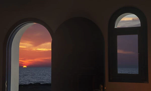 View Of A Colourful, Dramatic Sunset Over The Ocean Through An Arched Doorway; Paphos, Cyprus
