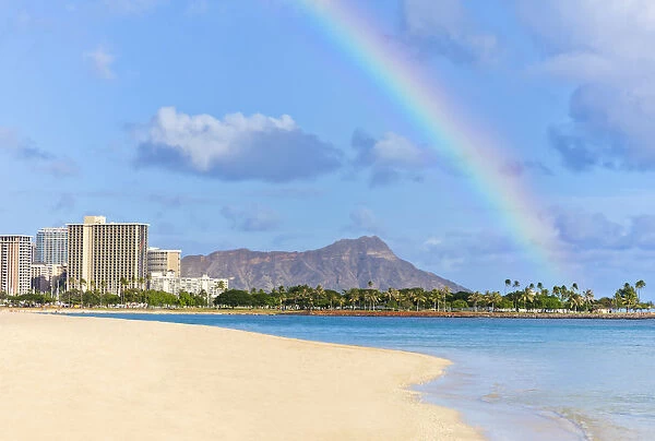 View Of Waikiki Beach And Diamond Head Crater At Ala Moana Beach Park With A Rainbow Overhead; Honolulu, Oahu, Hawaii, United States Of America