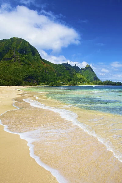Water Washing Up Onto The Sand Along The Coast; Wailua, Hawaii, United States Of America