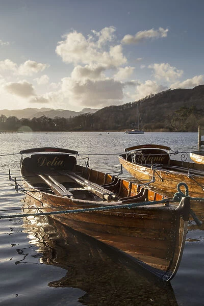 Woden Boats Tied At The Waters Edge On A Tranquil Lake; South Lakeland District, England