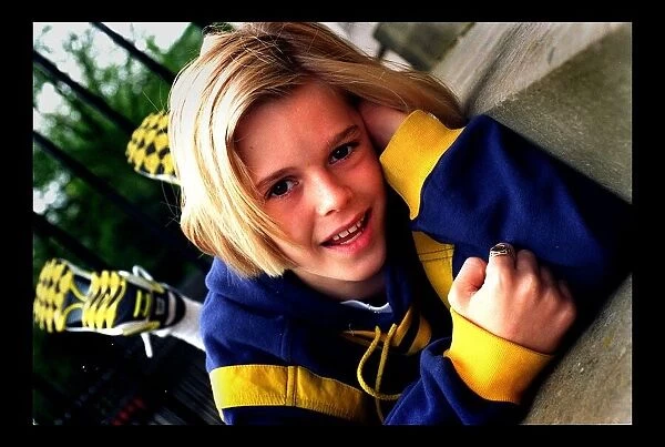 10 year old pop star Aaron Carter May 1998 lying on a step