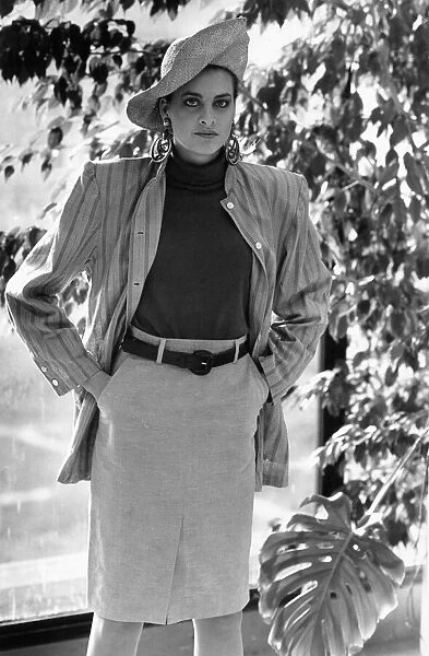 1980s Womens Fashion: Our model wears a waist high belted skirt a stripe jacket over