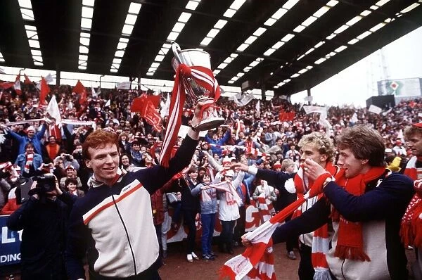 Aberdeens Alex McLeish holding the European Cup Winners Cup trophy aloft for fans