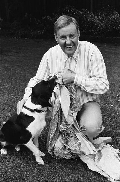 Actor Richard Briers seen here in the back garden of his West London home with his dog