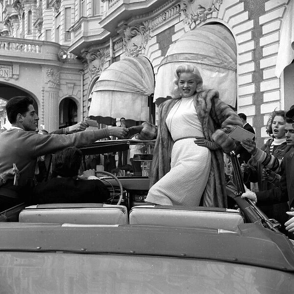 Actress Diana Dors surrounded by autograph hunters at Cannes Film Festival May