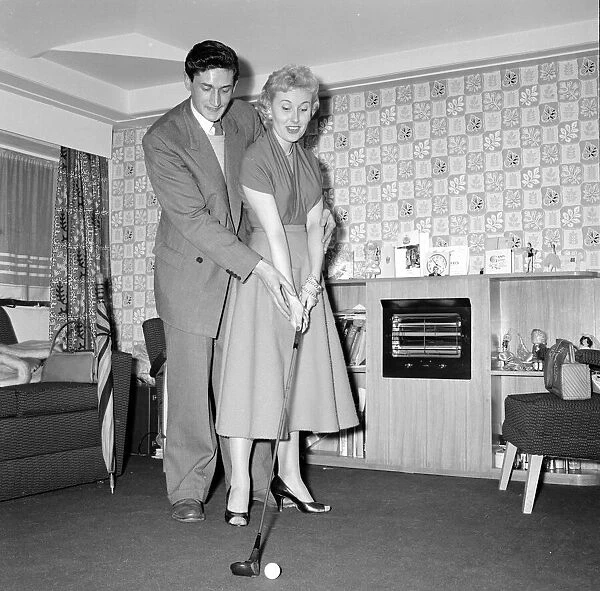 Actress and singer Jill Day seen here getting a golf lesson Circa 1957