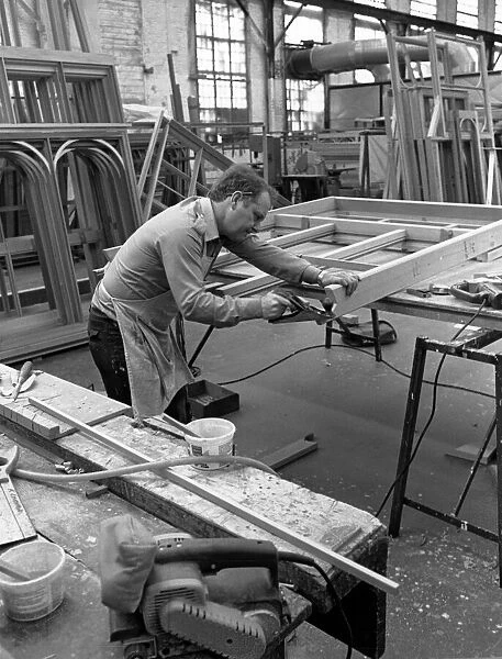 Amdega Conservatories. Joiner puts the finishing touches to one of the joints of a