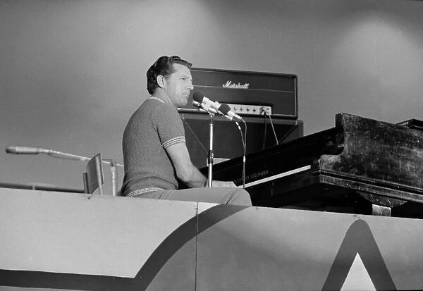 American rock and roll singer and musician Jerry Lee Lewis performing on stage at a rock