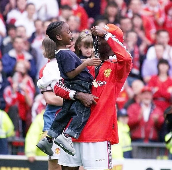 Andy Cole Football player for Manchester United May 1999 showing his son Devante