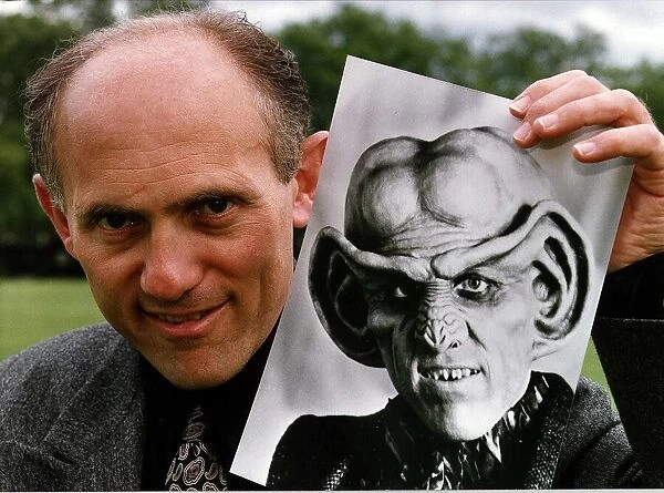 Armin Shimerman American Actor Holding A Picture Of Quark Who He Stars As In Star Trek