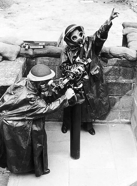 ATS women wearing full gas equipment train on range finders at a London gun site during
