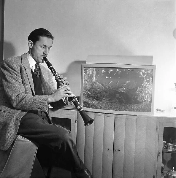 Band leader Nat Temple playing his clarinet at his home March 1953 C4833-001