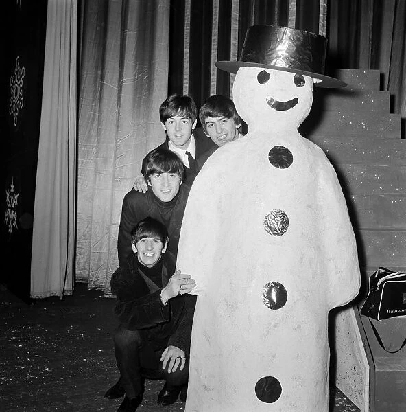 The Beatles at Finsbury Park Astoria, posing next to a snowman
