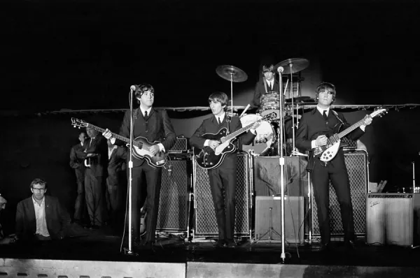 The Beatles performing on stage at the Forest Hills Tennis Stadium in New York during