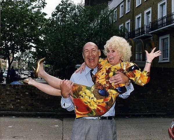 Bernard Bresslaw Actor holding actress Barbara Windsor in his arms