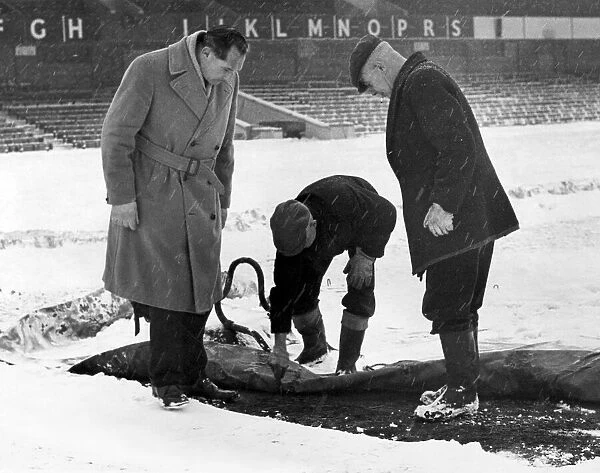 Birmingham City manager Gil Merrick (left) takes a close look at the St Andrews pitch as