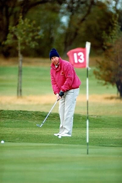 Bobby Charlton playing golf in November 1990