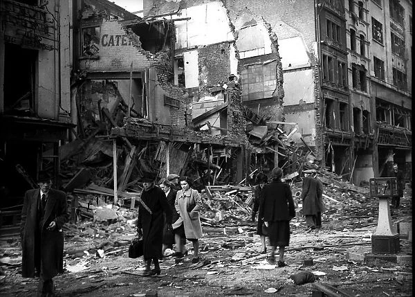 Bomb damage in London during WW2 people walking past detroyed buildings