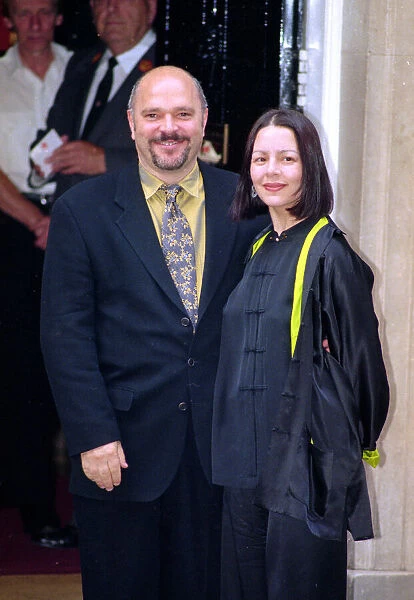 British film producer Anthony Minghella arrives at Number 10 Downing Street with his wife