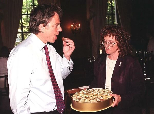 British Prime Minister Tony Blair accepts a chocolate from Judy Mallaber MP for Amber