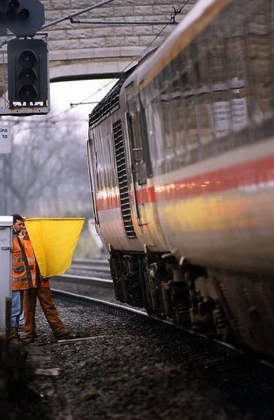 A British Rail workman using the old fashioned hand and flag signal on 1st, December 1994