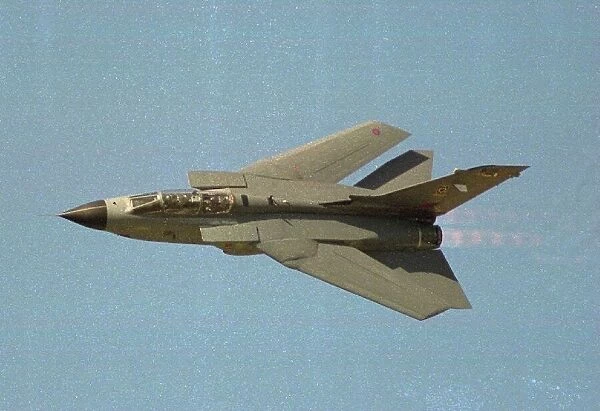 A British Tornado GR1 fighter flies at speed with wings swept back at the Farnborough Air