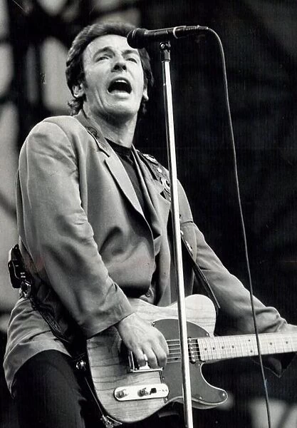 Bruce Springsteen performing on stage during a concert at Villa Park