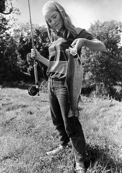 Celia Reade, aged 14 seen here shortly after landing a trout following a fishing lesson
