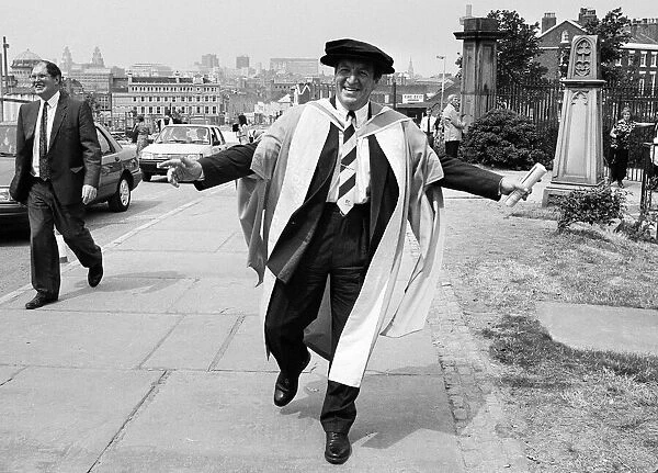 Former chairman of Next George Davies, shows off his robes for the degree ceremony of