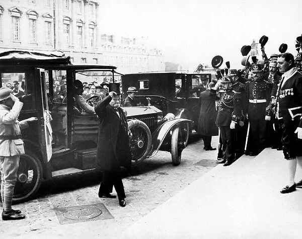 Cheering crowds greet French Premier Georges Clemenceau as he arrives at the Palace of