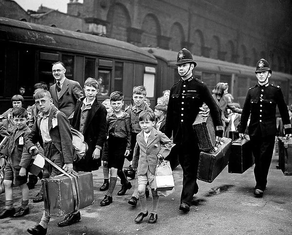 Children being evacuated from London July 1944. Children boarding train get help