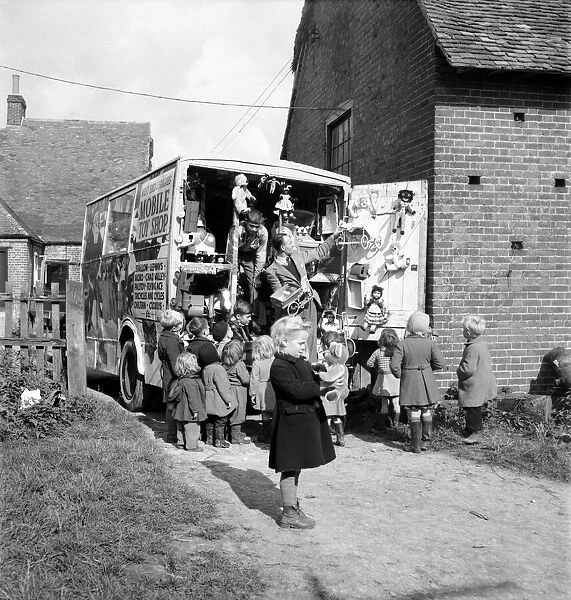 Children look at goods on display at a Mobile Toy Shop - in Kent