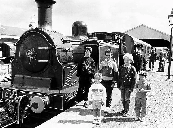 Children stand next to the Caledonian loco No 419 Steam Train owned by the Scottish