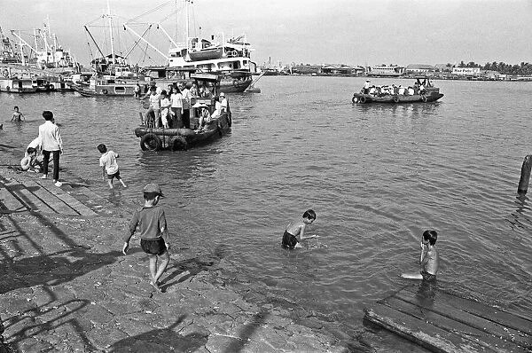 Children swimming in the Saigon River on the eve of Tet, the Vietnamese new year