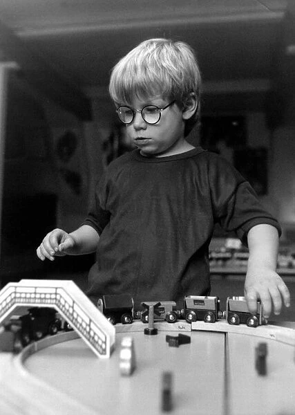 Children - Toys Young Boy playing with a Train Set - at a creche at Kingway