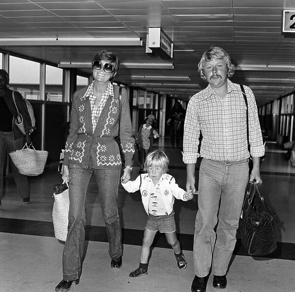 Cilla Black arrives at Heathrow Airport with her husband Bobby Willis