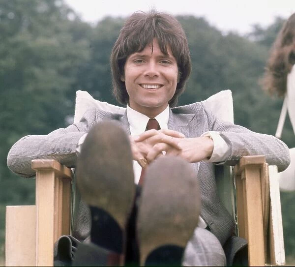 Cliff Richard seen here relaxing between takes on location filming for '