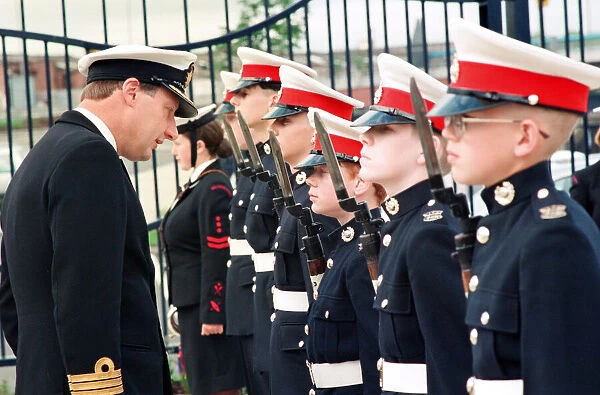 Commander J Robertson inspects the guard of honour provided by the Marines detachment