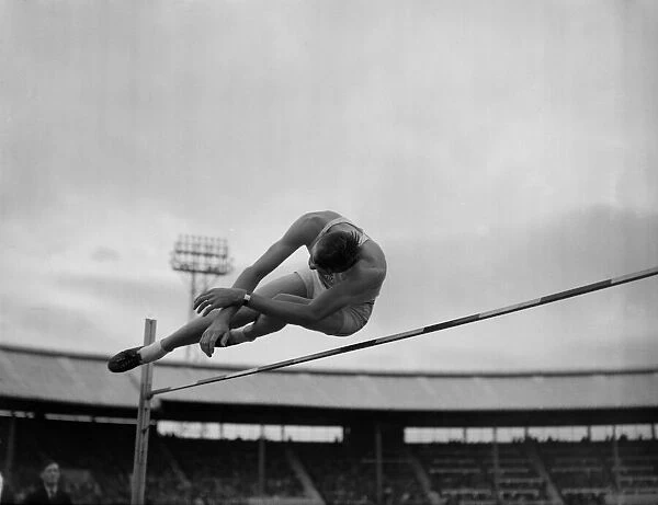 A competitor taking part in the pole vault during the British Games at White City 1950