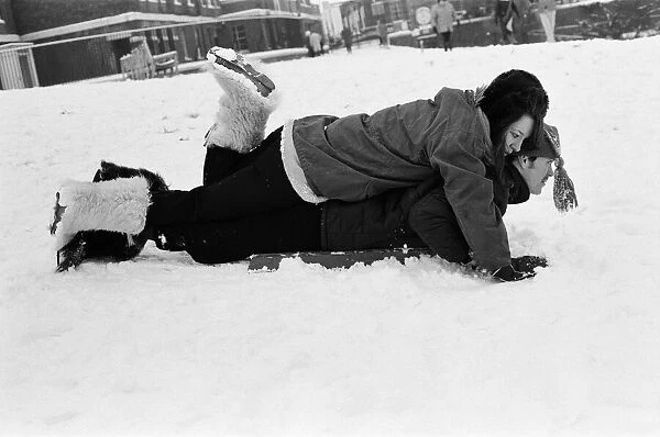 A couple sledging in Greenwich Park, London, 27th December 1970