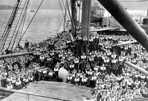 Crowded decks following a drill on board a British troopship carrying soldiers of
