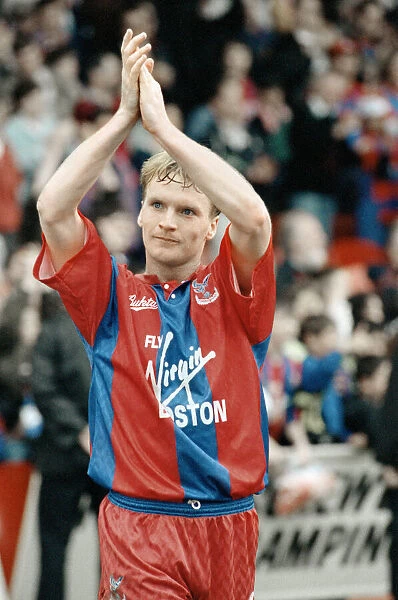 Crystal Palace midfielder Geoff Thomas applauds the supporters after his side